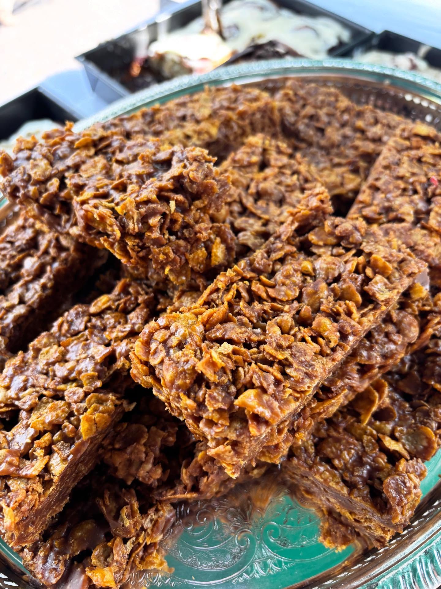 Chocolate cornflake traybakes piled on a silver platter