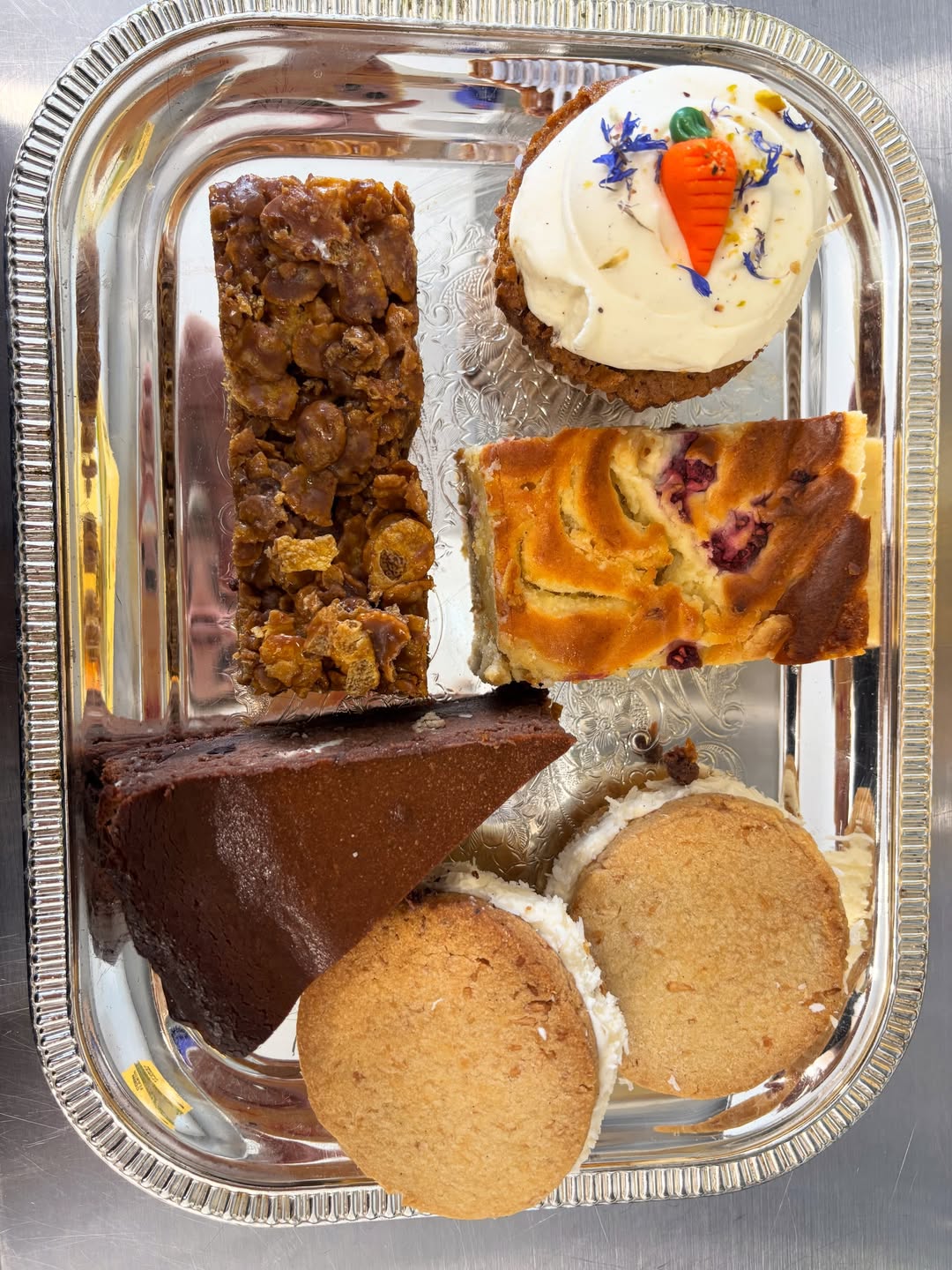 A silver tray filled with five different Melys bakes